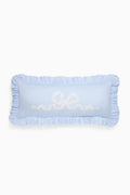 Light blue decorative pillow with ruffled edges and embroidered text on a white background