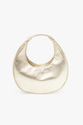 Bolso Eclipse Dorado de Lady Pipa para completar looks de invitada.
