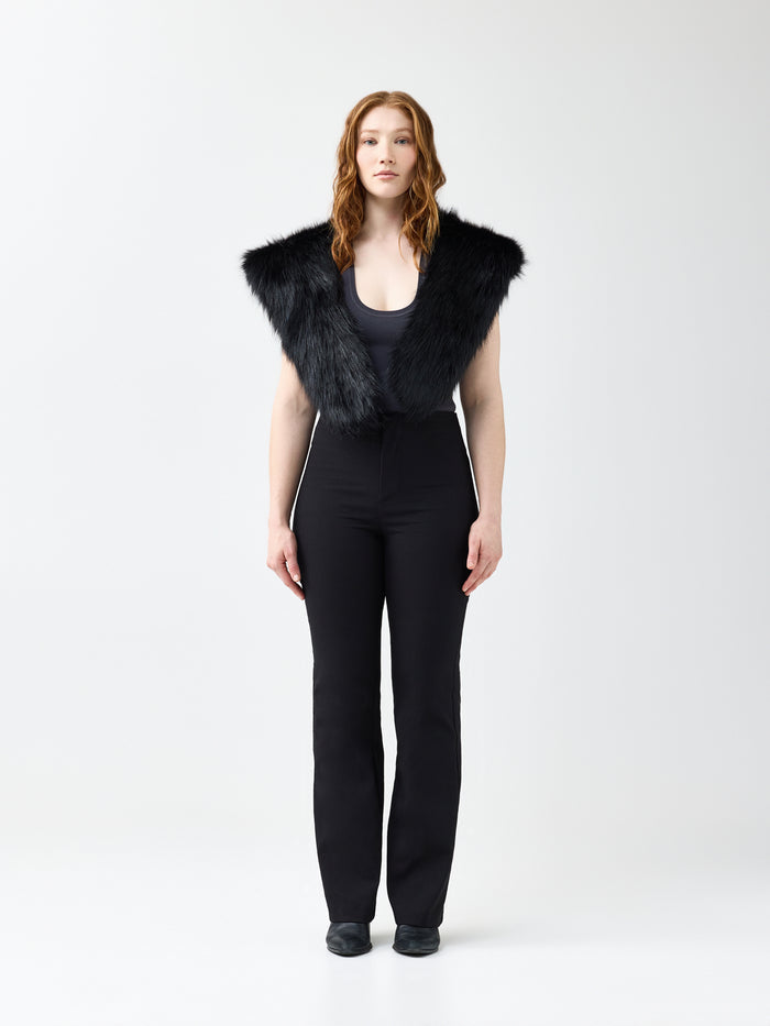 Woman wearing a black faux fur wrap scarf on a white background