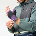 rock climber tighening his purple Wild Country Crack Gloves