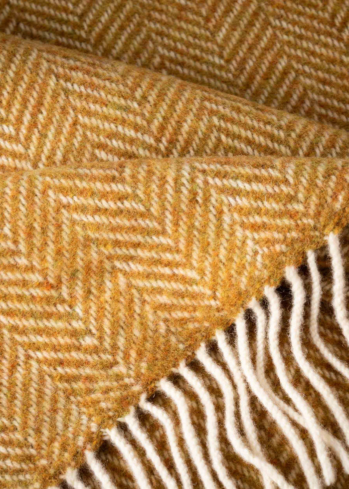 Close-up of a textured fabric with a herringbone pattern in brown and white.