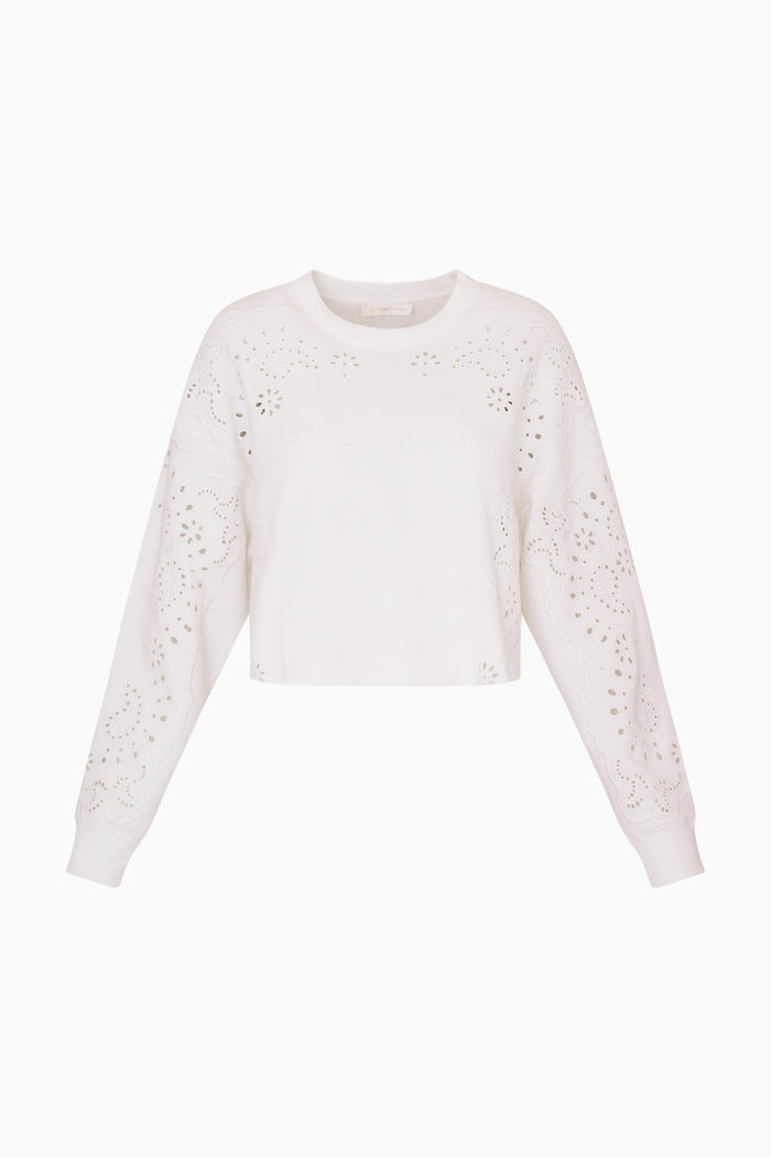 White eyelet accented pullover against a white background