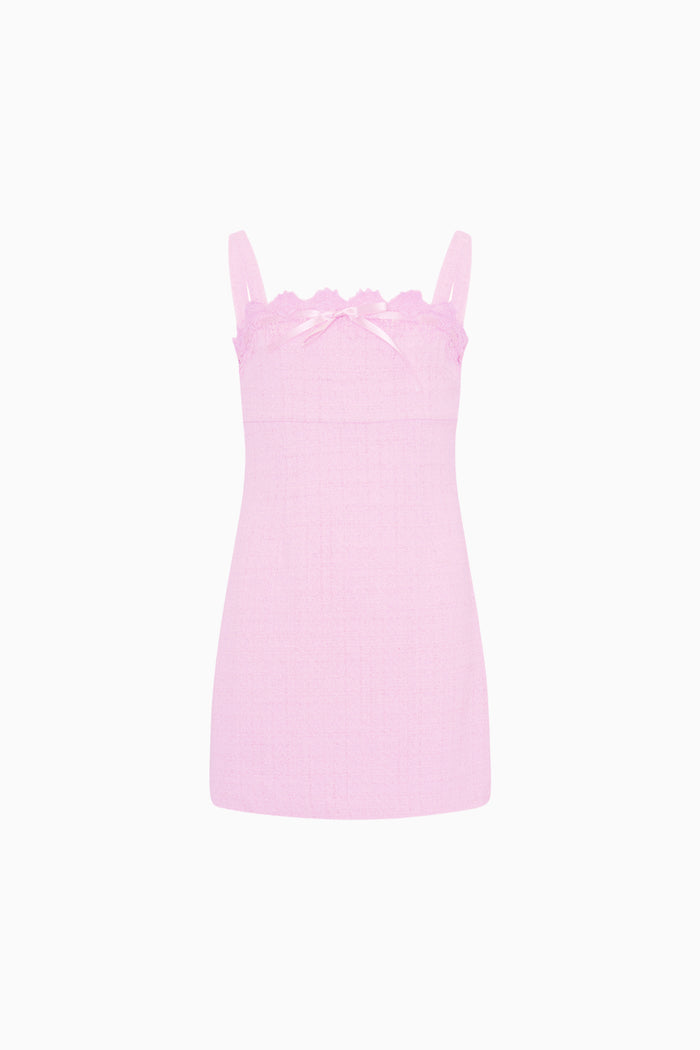 Pink slip dress with scalloped lace trim on a white background