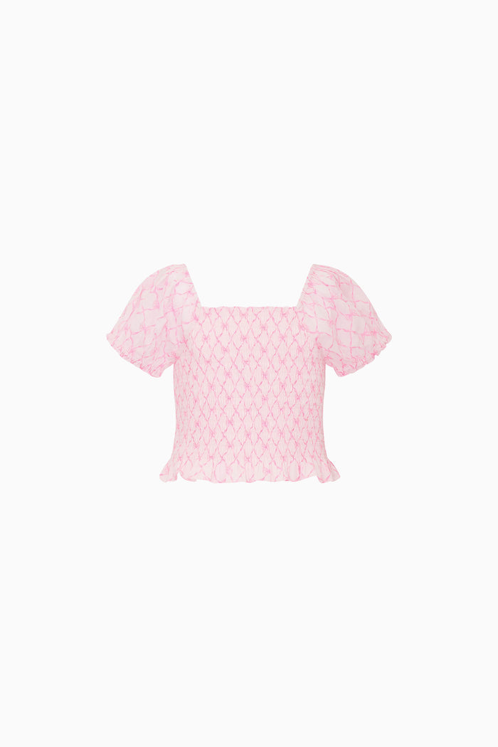 Pink bow print top on a white background
