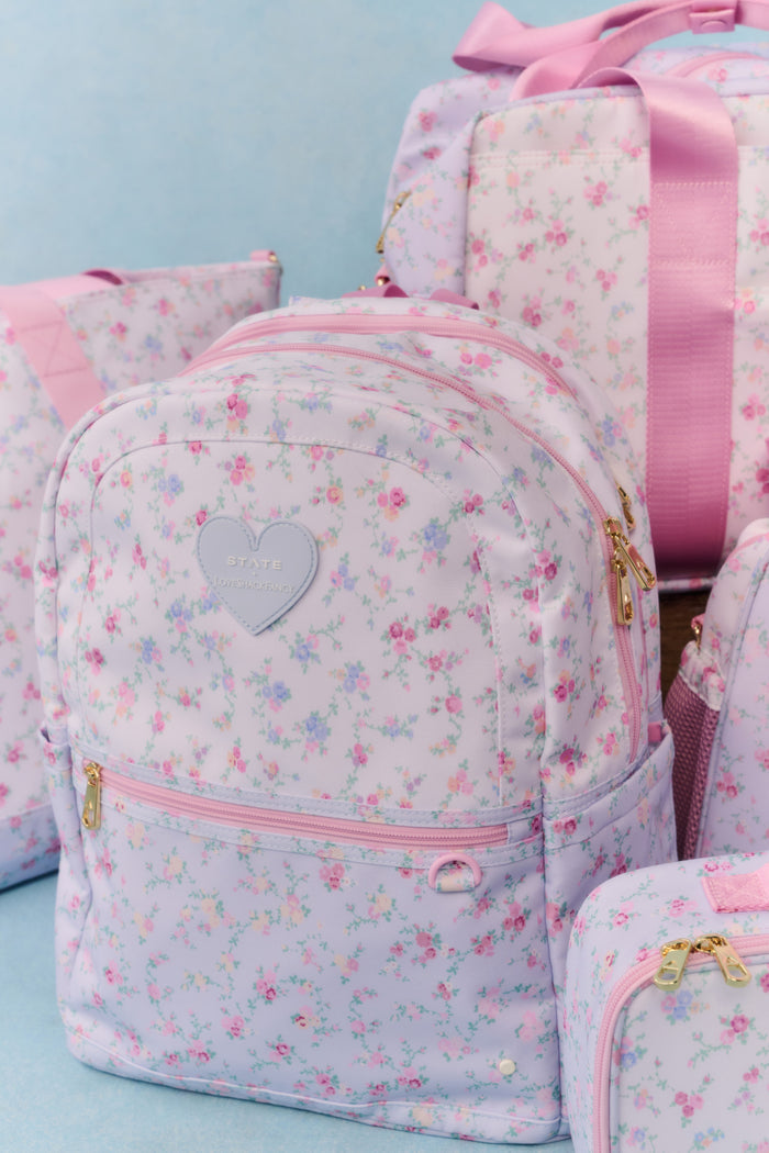 Floral-patterned backpack with pink accents on a light blue background