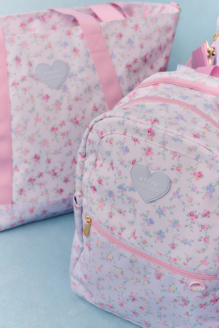 Floral-patterned backpack with pink accents on a light blue background