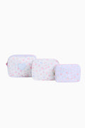 Three light blue travel cases with flower patterns on a white background