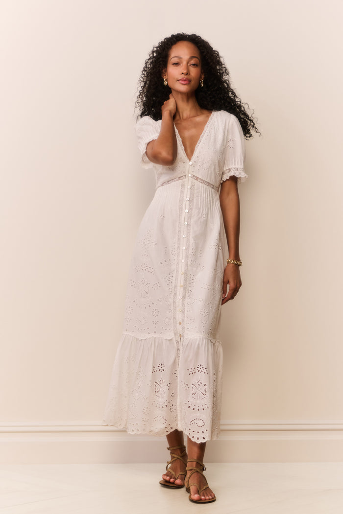 Woman wearing short sleeve white lace eyelet cutout long dress