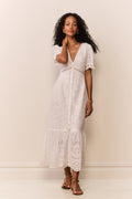 Woman wearing short sleeve white lace eyelet cutout long dress