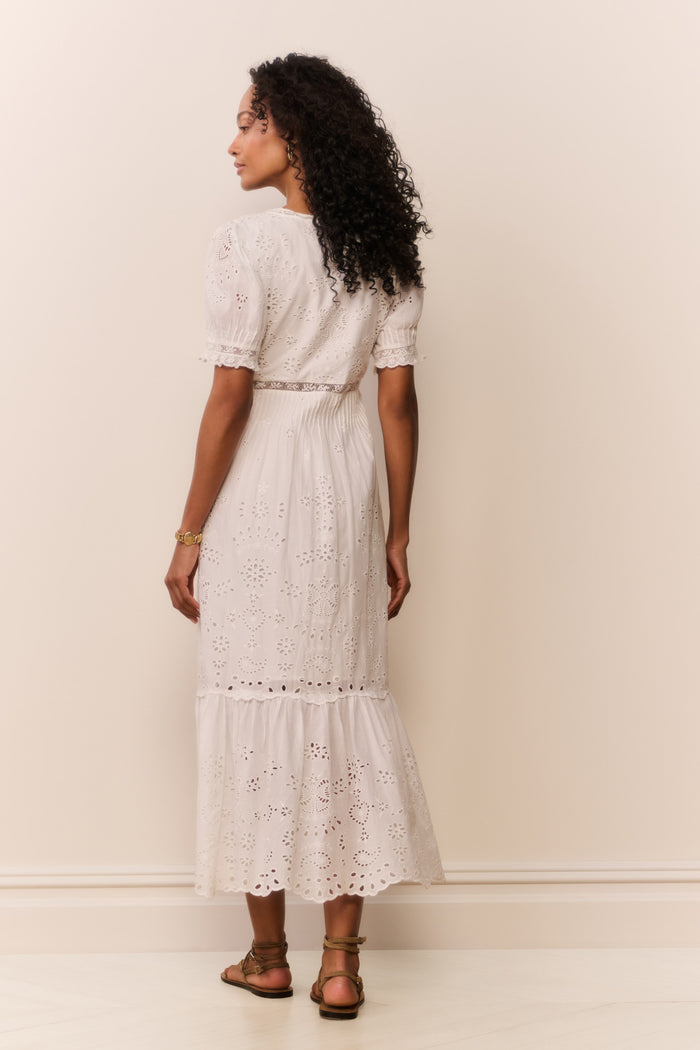 Woman wearing short sleeve white lace eyelet cutout long dress