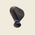 Black Therabody device on a beige background