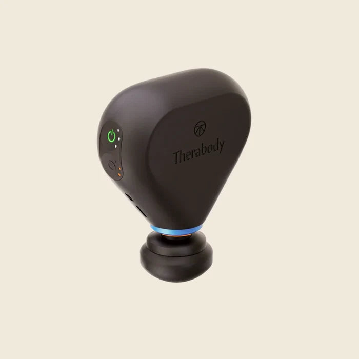 Black handheld device with Therabody branding on a beige background
