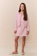 Girl wearing pink linen mini dress with matching lace trim evening jacket