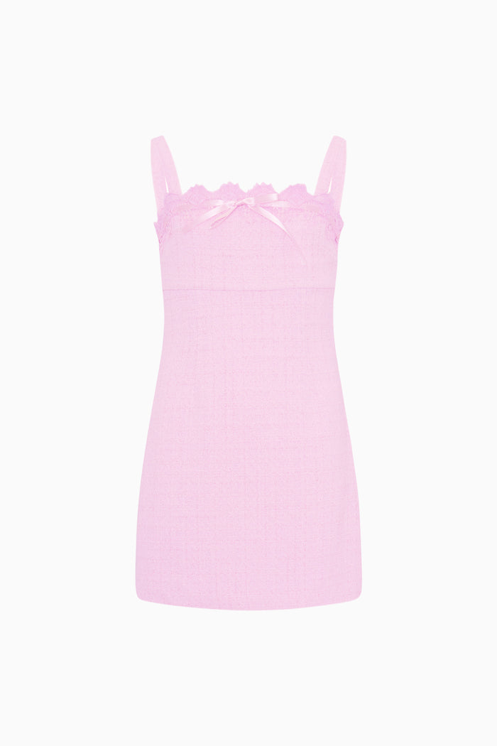 Pink slip dress with lace details on a white background