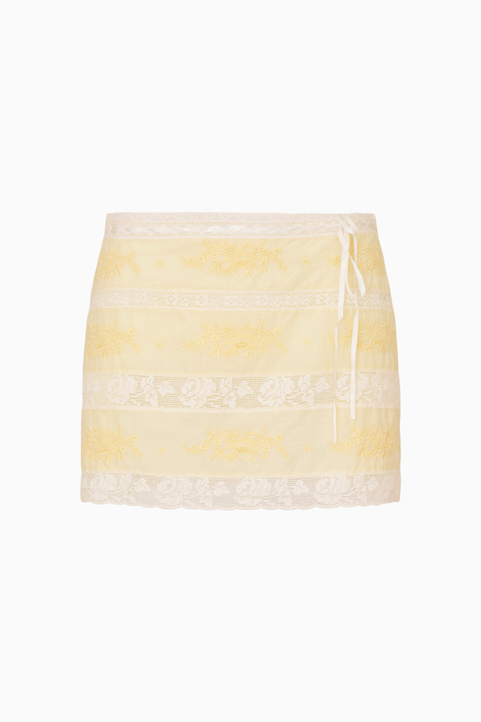 Yellow and white lace striped mini skirt with lace trim on a white background