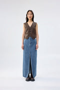 Brown vegan leather vest with button-front closure and V-neckline, worn over a blue denim maxi skirt, front view